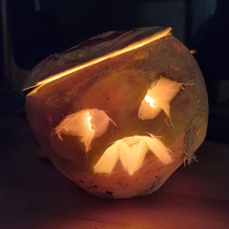 Another scary face carved into a turnip. Shown in the dark with a small tealight inside to light up the features. Photo credit: Neil Williamson.